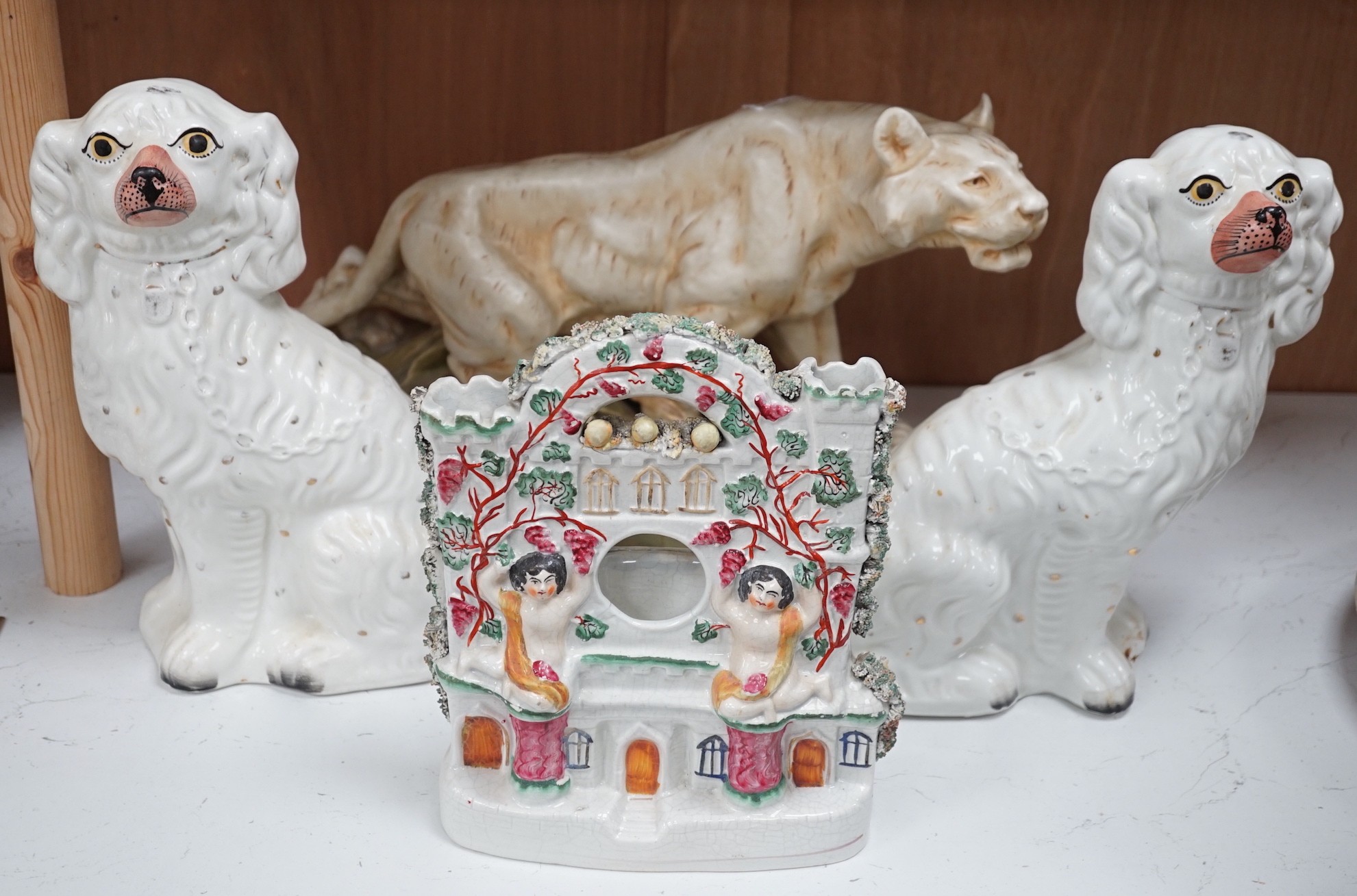 A Royal Dux tiger, a pair of Staffordshire Spaniels and a figural flat back, tiger 28cms high